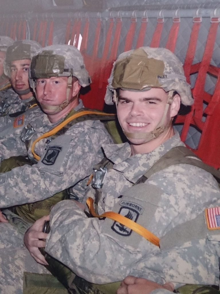 Joshua Nunley as a Paratrooper with group of men beside him
